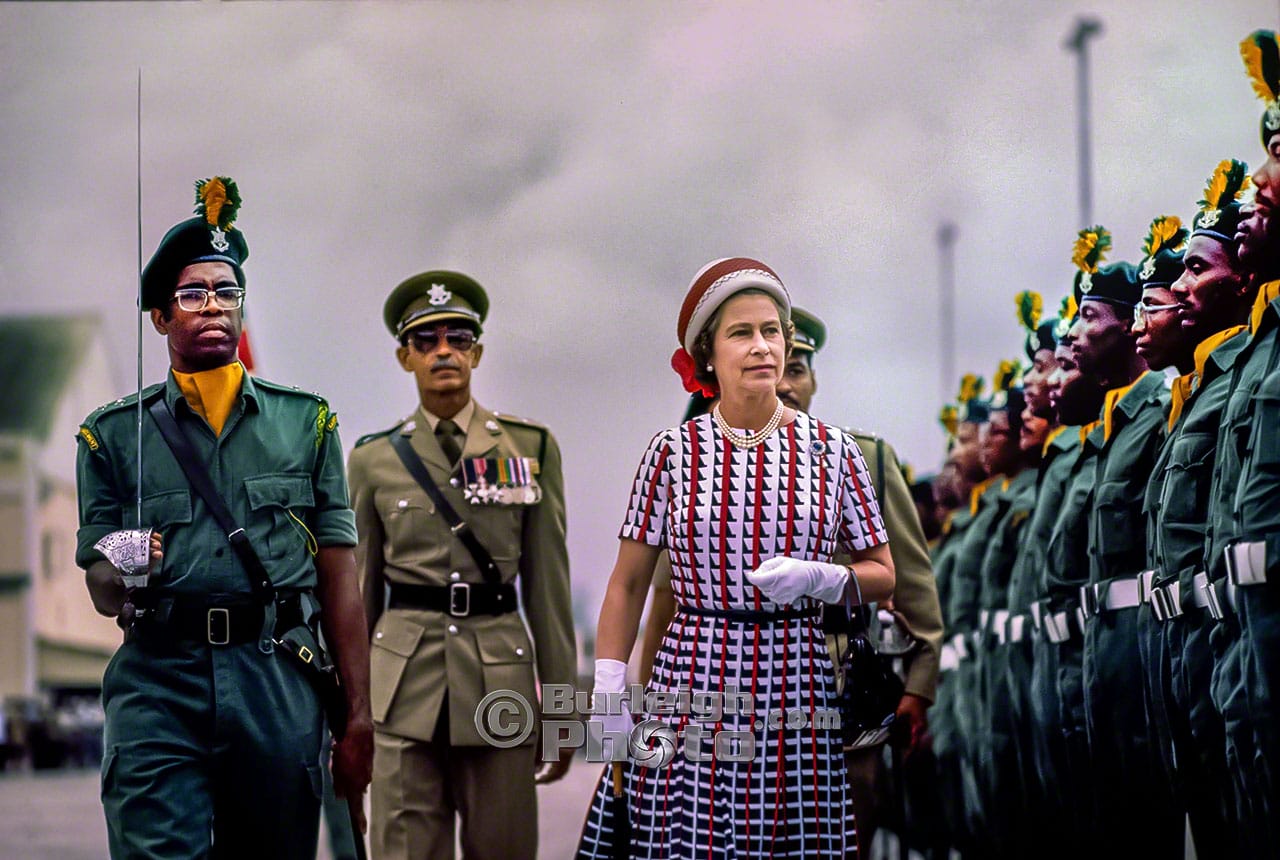 Queen Elizabeth inspects the Royal Guard at the Bridgetown Port before leaving for her first event
